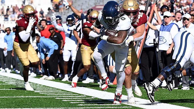 Oct 28, 2023; Chestnut Hill, Massachusetts, USA; Connecticut Huskies running back Camryn Edwards (0) rushes against the Boston College Eagles during the first half at Alumni Stadium. Mandatory Credit: Brian Fluharty-USA TODAY Sports