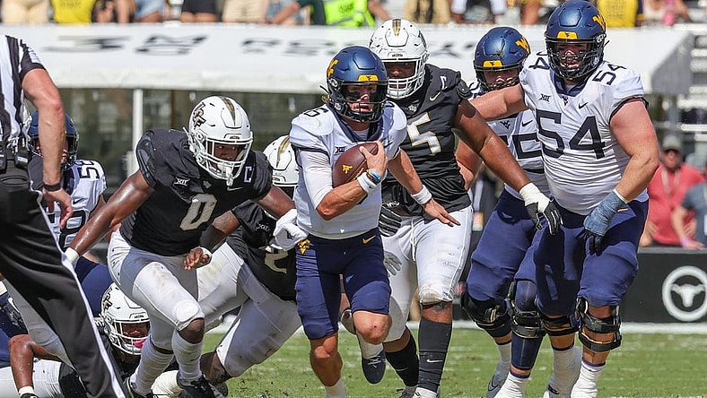 Oct 28, 2023; Orlando, Florida, USA; West Virginia Mountaineers quarterback Garrett Greene (6) carries the ball during the second quarter against the UCF Knights at FBC Mortgage Stadium. Mandatory Credit: Mike Watters-USA TODAY Sports