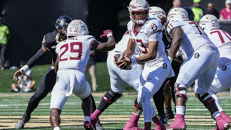 Oct 28, 2023; Winston-Salem, North Carolina, USA; Florida State Seminoles quarterback Jordan Travis (13) hands off the ball to running back Rodney Hill (29) during the first half against the Wake Forest Demon Deacons at Allegacy Federal Credit Union Stadium. Mandatory Credit: Jim Dedmon-USA TODAY Sports