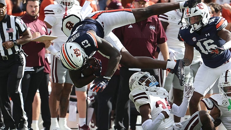 Oct 28, 2023; Auburn, Alabama, USA;  Auburn Tigers tight end Rivaldo Fairweather (13) is flipped up by Mississippi State Bulldogs cornerback Brice Pollock (34) during the first quarter at Jordan-Hare Stadium. Mandatory Credit: John Reed-USA TODAY Sports