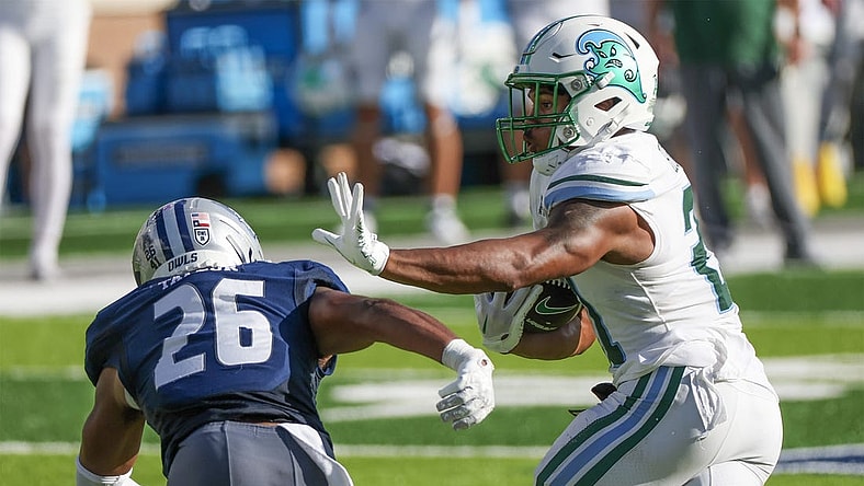 Oct 28, 2023; Houston, Texas, USA; Tulane Green Wave running back Makhi Hughes (21) stiff arms Rice Owls safety Gabriel Taylor (26) in the first half at Rice Stadium. Mandatory Credit: Thomas Shea-USA TODAY Sports