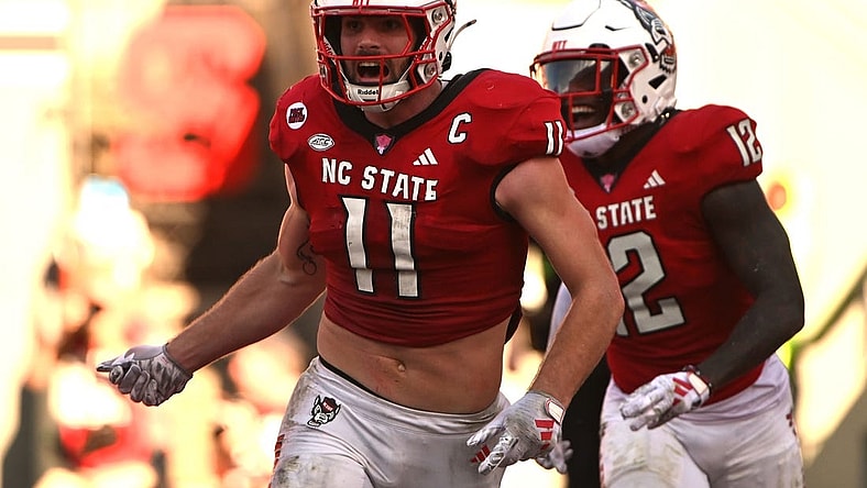 Oct 28, 2023; Raleigh, North Carolina, USA; North Carolina State Wolfpack linebacker Payton Wilson (11) celebrates after scoring a touchdown on an interception during the second half against the Clemson Tigers at Carter-Finley Stadium. Mandatory Credit: Rob Kinnan-USA TODAY Sports