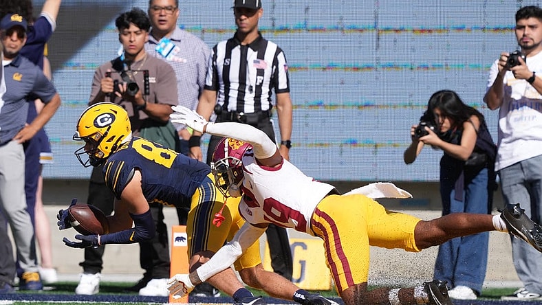 Oct 28, 2023; Berkeley, California, USA; California Golden Bears wide receiver Trond Grizzell (left) catches a touchdown pass against USC Trojans safety Jaylin Smith (right) during the second quarter at California Memorial Stadium. Mandatory Credit: Darren Yamashita-USA TODAY Sports