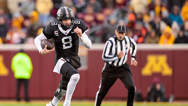 Oct 28, 2023; Minneapolis, Minnesota, USA;  Minnesota Golden Gophers quarter back Athan Kaliakmanis (8) runs for a first down against the Michigan State Spartans during the fourth quarter at Huntington Bank Stadium. Mandatory Credit: Nick Wosika-USA TODAY Sports