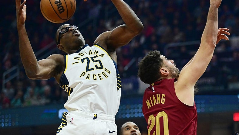 Oct 28, 2023; Cleveland, Ohio, USA; Indiana Pacers forward Jalen Smith (25) goes for a rebound against Cleveland Cavaliers forward Georges Niang (20) during the first half at Rocket Mortgage FieldHouse. Mandatory Credit: Ken Blaze-USA TODAY Sports
