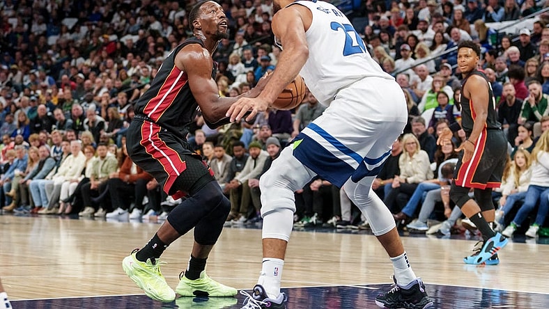Oct 28, 2023; Minneapolis, Minnesota, USA; Miami Heat center Bam Adebayo (13) shoots the ball as Minnesota Timberwolves center Rudy Gobert (27) defends in the first quarter at Target Center. Mandatory Credit: Matt Blewett-USA TODAY Sports