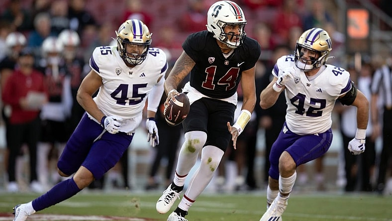 Oct 28, 2023; Stanford, California, USA; Stanford Cardinal quarterback Ashton Daniels (14) scrambles away from defensive pressure by Washington Huskies edge rusher Maurice Heims (45) and linebacker Carson Bruener (42) during the first quarter at Stanford Stadium. Mandatory Credit: D. Ross Cameron-USA TODAY Sports