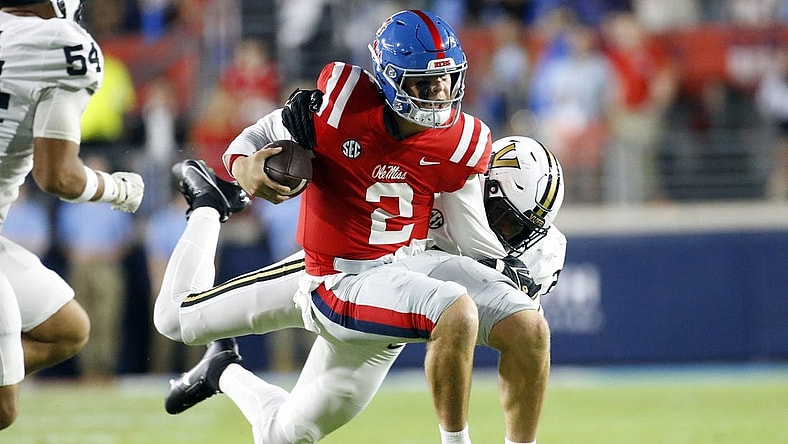 Oct 28, 2023; Oxford, Mississippi, USA; Mississippi Rebels quarterback Jaxson Dart (2) runs with the ball as he is tackled by Vanderbilt Commodores defensive end-linebacker Miles Capers (29) during the first half at Vaught-Hemingway Stadium. Mandatory Credit: Petre Thomas-USA TODAY Sports