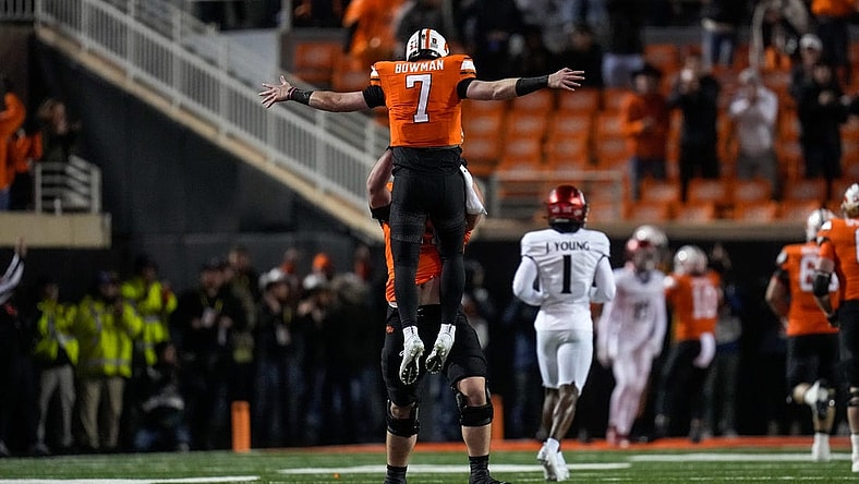 Oklahoma State Cowboys quarterback Alan Bowman (7) and offensive lineman Dalton Cooper (71) celebrate a touchdown pass in the first quarter of the NCAA Big12 football game between the Oklahoma State Cowboys and the Cincinnati Bearcats at Boone Pickens Stadium in Stillwater, Okla., on Saturday, Oct. 28, 2023.