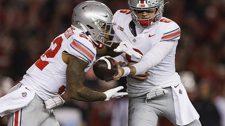 Oct 28, 2023; Madison, Wisconsin, USA;  Ohio State Buckeyes quarterback Kyle McCord (6) hands the football off to running back TreVeyon Henderson (32) during the third quarter against the Wisconsin Badgers at Camp Randall Stadium. Mandatory Credit: Jeff Hanisch-USA TODAY Sports