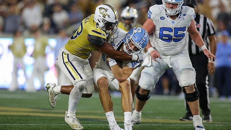 Oct 28, 2023; Atlanta, Georgia, USA; Georgia Tech Yellow Jackets linebacker Paul Moala (13) tackles North Carolina Tar Heels quarterback Drake Maye (10) in the second half at Bobby Dodd Stadium at Hyundai Field. Mandatory Credit: Brett Davis-USA TODAY Sports