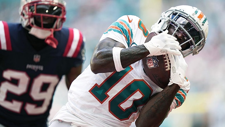 Miami Dolphins wide receiver Tyreek Hill (10) catches a touchdown over New England Patriots cornerback J.C. Jackson (29) during the first half of an NFL game at Hard Rock Stadium in Miami Gardens, Oct. 29, 2023.