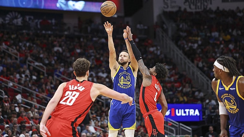 Oct 29, 2023; Houston, Texas, USA; Golden State Warriors guard Stephen Curry (30) shoots the ball as Houston Rockets guard Jalen Green (4) defends during the second quarter at Toyota Center. Mandatory Credit: Troy Taormina-USA TODAY Sports