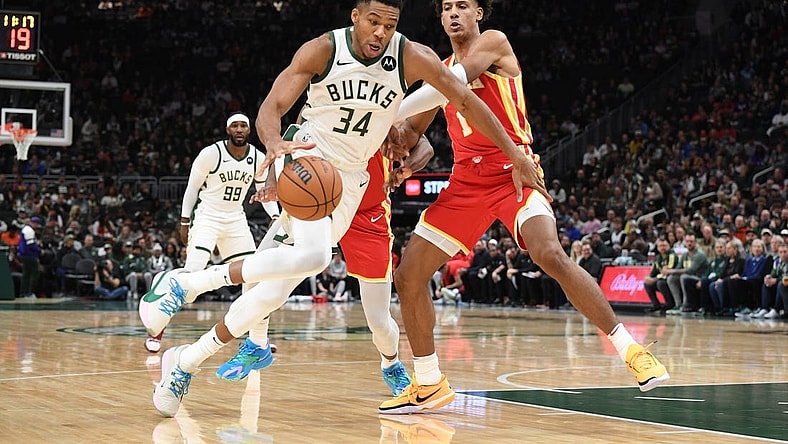 Oct 29, 2023; Milwaukee, Wisconsin, USA; Milwaukee Bucks forward Giannis Antetokounmpo (34) drives to the basket against Atlanta Hawks forward Jalen Johnson (1) in the first half at Fiserv Forum. Mandatory Credit: Michael McLoone-USA TODAY Sports