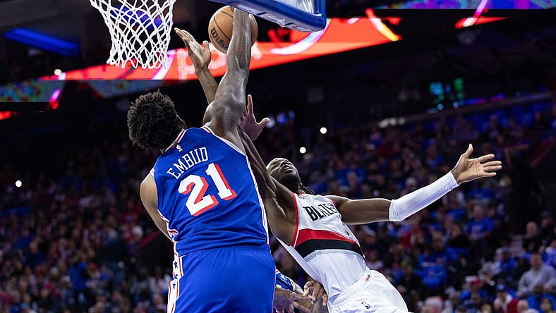 Oct 29, 2023; Philadelphia, Pennsylvania, USA; Philadelphia 76ers center Joel Embiid (21) blocks the drive of Portland Trail Blazers forward Jerami Grant (9) during the second quarter at Wells Fargo Center. Mandatory Credit: Bill Streicher-USA TODAY Sports