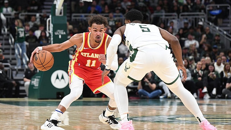 Oct 29, 2023; Milwaukee, Wisconsin, USA; Atlanta Hawks guard Trae Young (11) brings the ball up the court against Milwaukee Bucks guard Malik Beasley (5) in the second half at Fiserv Forum. Mandatory Credit: Michael McLoone-USA TODAY Sports