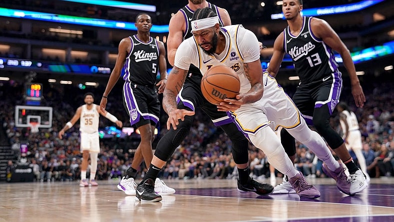 Oct 29, 2023; Sacramento, California, USA; Los Angeles Lakers forward Anthony Davis (3) falls to the ground after being fouled by Sacramento Kings forward Domantas Sabonis (10) in the second quarter at the Golden 1 Center. Mandatory Credit: Cary Edmondson-USA TODAY Sports