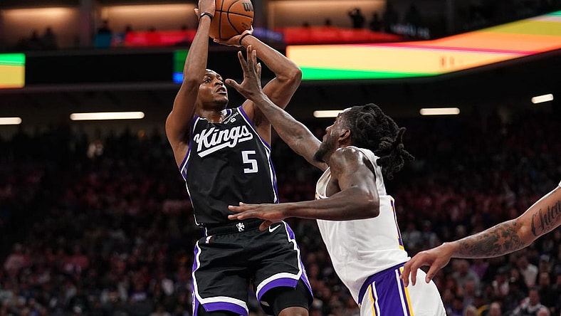 Oct 29, 2023; Sacramento, California, USA; Sacramento Kings guard De'Aaron Fox (5) shoots the ball over Los Angeles Lakers forward Taurean Prince (12) in the fourth quarter at the Golden 1 Center. Mandatory Credit: Cary Edmondson-USA TODAY Sports