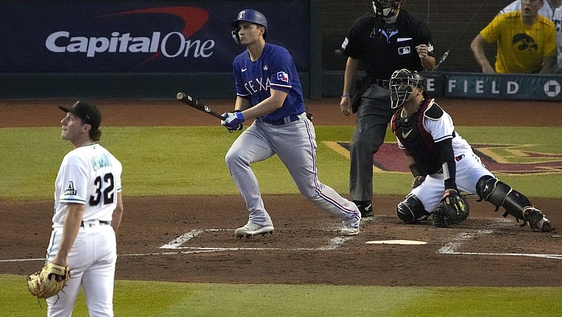 Oct 30, 2023; Phoenix, AZ, USA; Texas Rangers shortstop Corey Seager (5) hits a two-run home off Arizona Diamondbacks pitcher Brandon Pfaadt (32) during the third inning in game three of the 2023 World Series at Chase Field. Mandatory Credit: Rick Scuteri-USA TODAY Sports
