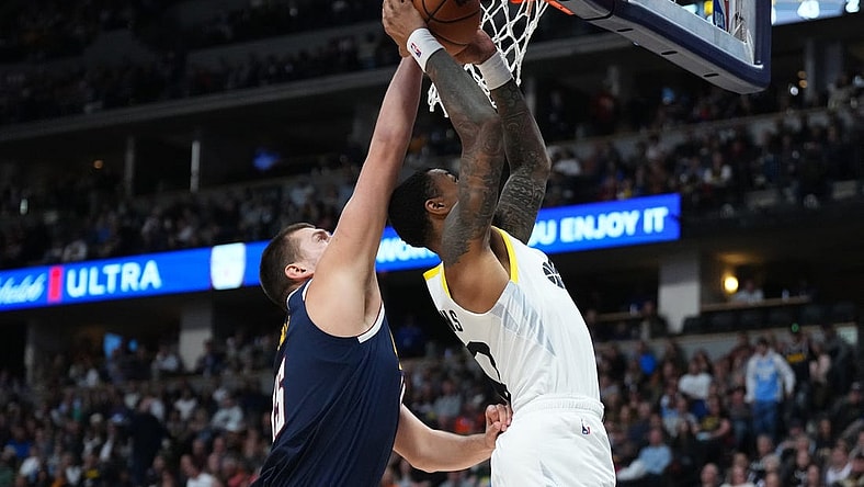 Oct 30, 2023; Denver, Colorado, USA; Denver Nuggets center Nikola Jokic (15) blocks the shot of Utah Jazz forward John Collins (20) in the second quarter at Ball Arena. Mandatory Credit: Ron Chenoy-USA TODAY Sports