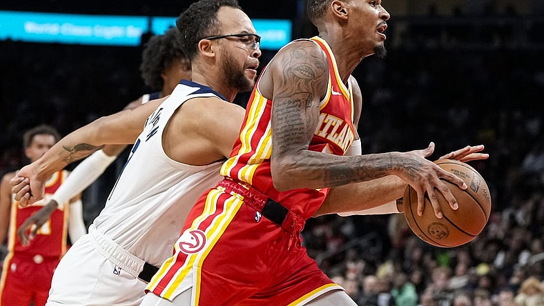 Oct 30, 2023; Atlanta, Georgia, USA; Atlanta Hawks guard Dejounte Murray (5) dribbles past Minnesota Timberwolves forward Kyle Anderson (1) during the second half at State Farm Arena. Mandatory Credit: Dale Zanine-USA TODAY Sports