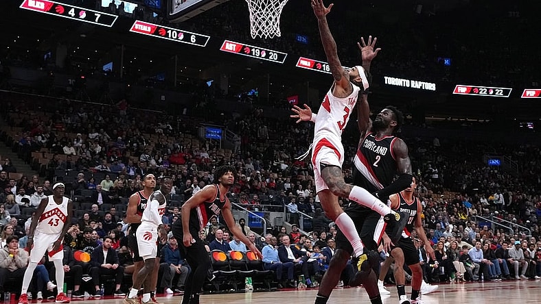 Oct 30, 2023; Toronto, Ontario, CAN; Toronto Raptors guard Gary Trent Jr. (33) drives to the basket over Portland Trail Blazers center Deandre Ayton (2) during the fourth quarter at Scotiabank Arena. Mandatory Credit: Nick Turchiaro-USA TODAY Sports