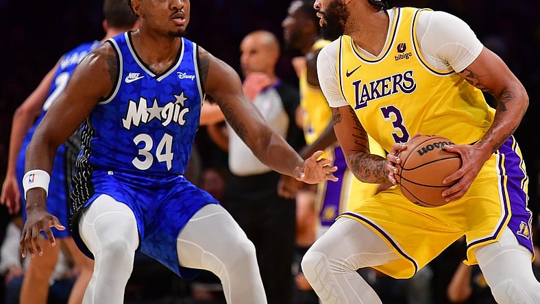 Oct 30, 2023; Los Angeles, California, USA; Los Angeles Lakers forward Anthony Davis (3) moves the ball against Orlando Magic center Wendell Carter Jr. (34) during the first half at Crypto.com Arena. Mandatory Credit: Gary A. Vasquez-USA TODAY Sports