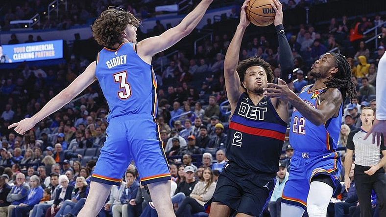 Oct 30, 2023; Oklahoma City, Oklahoma, USA; Detroit Pistons guard Cade Cunningham (2) drives to the basket between Oklahoma City Thunder guard Josh Giddey (3) and guard Cason Wallace (22) during the second half at Paycom Center. Oklahoma City won 124-112. Mandatory Credit: Alonzo Adams-USA TODAY Sports