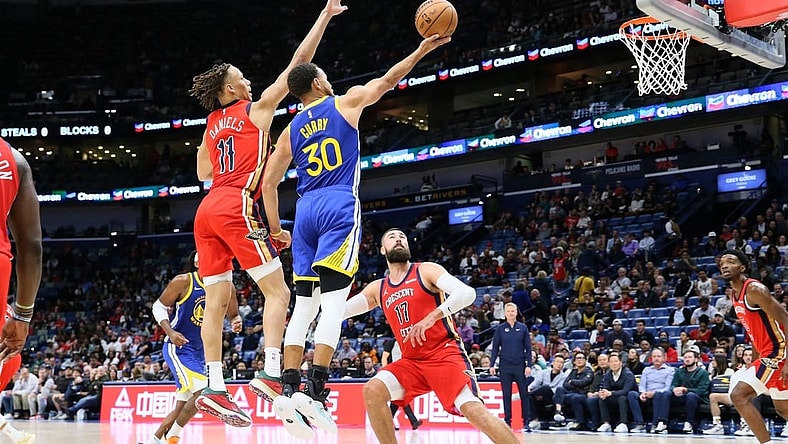 Oct 30, 2023; New Orleans, Louisiana, USA; Golden State Warriors guard Stephen Curry (30) drives to the basket against New Orleans Pelicans guard Dyson Daniels (11) and center Jonas Valanciunas (17) at Smoothie King Center. Mandatory Credit: Matthew Dobbins-USA TODAY Sports