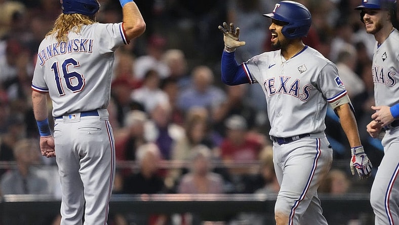 Texas Rangers right fielder Travis Jankowski (16) congratulates second baseman Marcus Semien (2) after a three-run home run during the third inning against the Arizona Diamondbacks in Game 4 of the 2023 World Series at Chase Field in Phoenix, AZ.