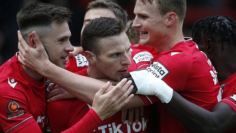 Wrexham's Paul Mullin celebrates scoring their second goal with teammates against Boreham Wood at the Racecourse Ground, Wrexham, Britain - April 22, 2023