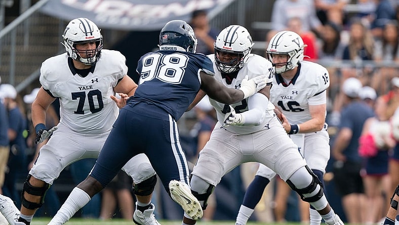 (File photo) Yale Bulldogs offensive lineman Kiran Amegadjie (72) blocks Connecticut Huskies defensive lineman Lwal Uguak (98) during the first half at Rentschler Field at Pratt & Whitney Stadium. Mandatory Credit: Gregory Fisher-USA TODAY Sports