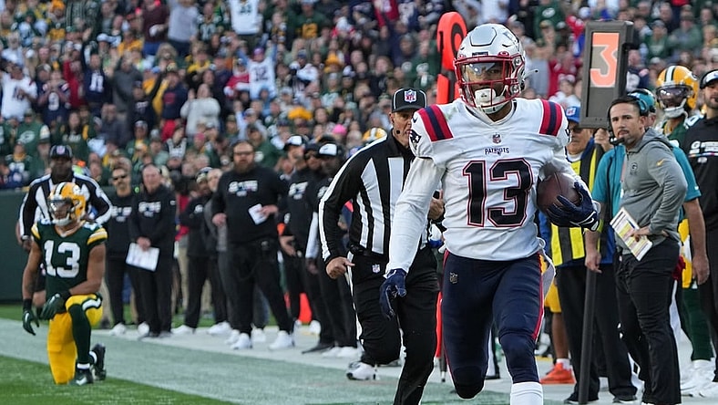New England Patriots defensive back Jack Jones returns an interception thrown by Green Bay Packers quarterback Aaron Rodgers for a touchdown during the second quarter of their game Sunday, October 2, 2022 at Lambeau Field in Green Bay, Wis.
Packers02 5
