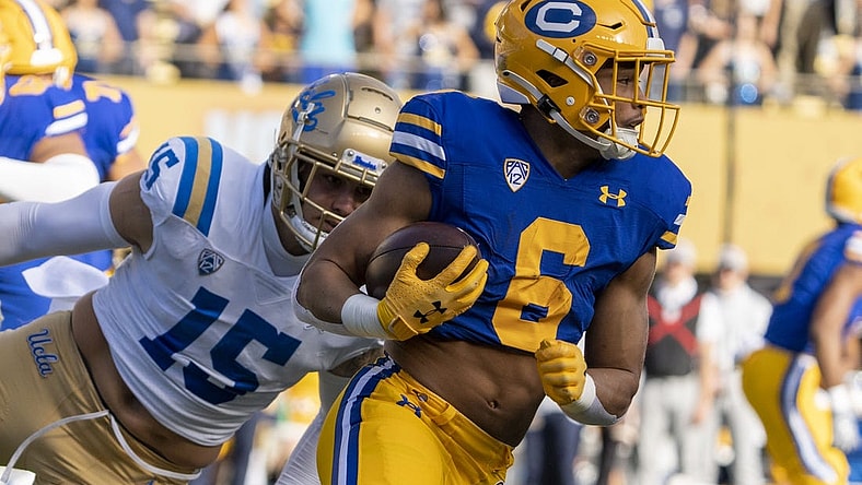 November 25, 2022; Berkeley, California, USA; California Golden Bears running back Jaydn Ott (6) runs the football against UCLA Bruins linebacker Laiatu Latu (15) during the first quarter at California Memorial Stadium. Mandatory Credit: Kyle Terada-USA TODAY Sports