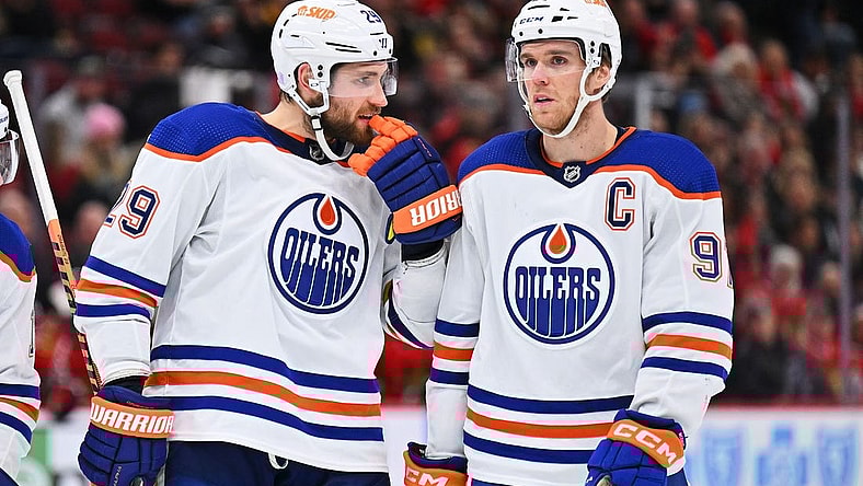 Nov 30, 2022; Chicago, Illinois, USA;  Edmonton Oilers forward Leon Draisaitl (29) and forward Connor McDavid (97) talk before a face off against the Chicago Blackhawks at United Center. Mandatory Credit: Jamie Sabau-USA TODAY Sports