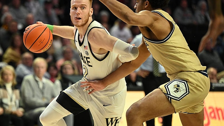 Feb 11, 2023; Winston-Salem, North Carolina, USA; Wake Forest Demon Deacons guard Cameron Hildreth (2) drives around Georgia Tech Yellow Jackets forward Jordan Meka (23) during the first half at Lawrence Joel Veterans Memorial Coliseum. Mandatory Credit: William Howard-USA TODAY Sports