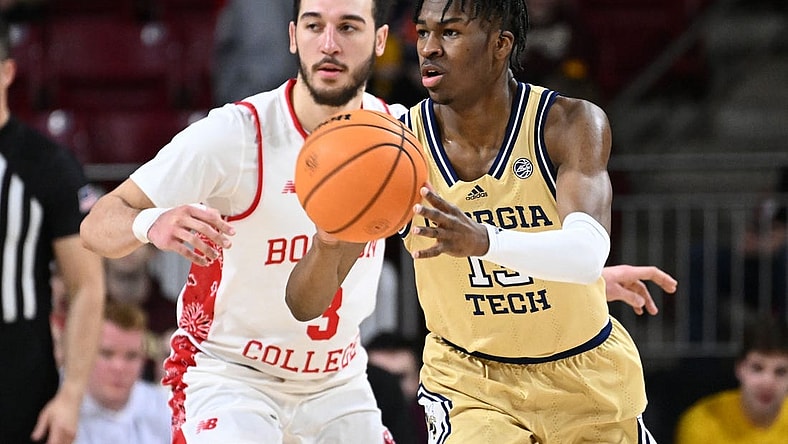 Mar 4, 2023; Chestnut Hill, Massachusetts, USA; Georgia Tech Yellow Jackets guard Miles Kelly (13) passes the ball past Boston College Eagles guard Jaeden Zackery (3) during the second half at the Conte Forum. Mandatory Credit: Brian Fluharty-USA TODAY Sports