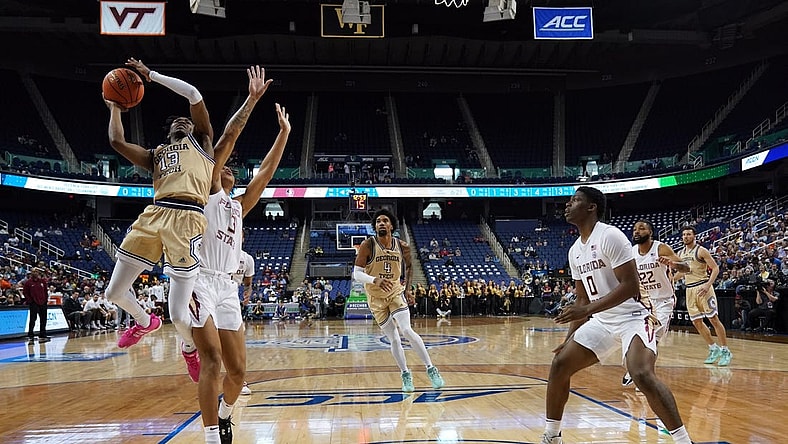 Mar 7, 2023; Greensboro, NC, USA; Georgia Tech Yellow Jackets guard Miles Kelly (13) goes up for a shot against Florida State Seminoles forward Cam Corhen (3) during the second half of the first round of the ACC tournament at Greensboro Coliseum. Mandatory Credit: John David Mercer-USA TODAY Sports
