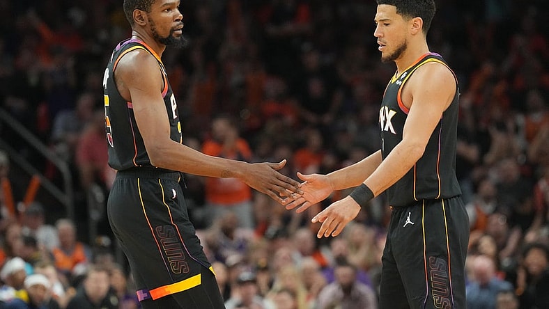 May 11, 2023; Phoenix, Arizona, USA; Phoenix Suns forward Kevin Durant (35) and Phoenix Suns guard Devin Booker (1) slap hands during the first half of game six of the 2023 NBA playoffs against the Denver Nuggets at Footprint Center. Mandatory Credit: Joe Camporeale-USA TODAY Sports
