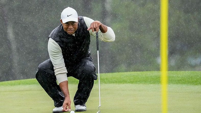 Tiger Woods lines up his putt on the 18th green during the second round of The Masters in April.