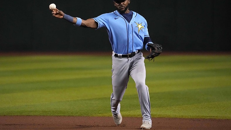 Jun 28, 2023; Phoenix, Arizona, USA; Tampa Bay Rays second baseman Vidal Brujan (7) throws to first base against the Arizona Diamondbacks during the seventh inning at Chase Field. Mandatory Credit: Joe Camporeale-USA TODAY Sports