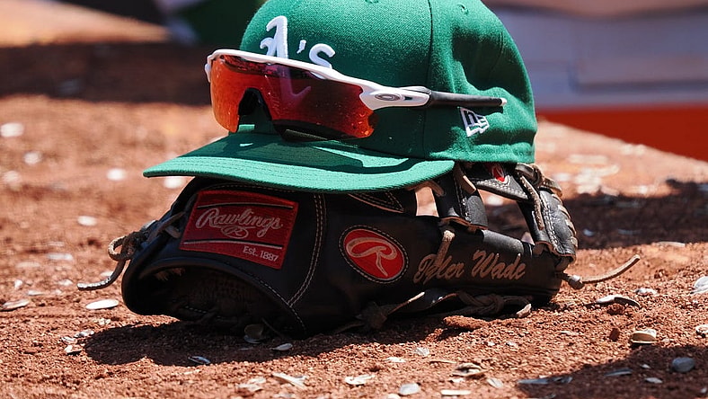 Jun 29, 2023; Oakland, California, USA; An Oakland Athletics hat on top of a glove during the eighth inning at Oakland-Alameda County Coliseum. Mandatory Credit: Kelley L Cox-USA TODAY Sports
