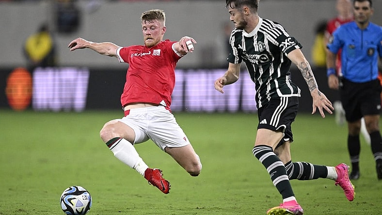 Jul 25, 2023; San Diego, California, USA; Wrexham midfielder Andy Cannon (20) and Manchester United forward Joe Hugill (52) battle for the ball during the second half at Snapdragon Stadium. Mandatory Credit: Orlando Ramirez-USA TODAY Sports