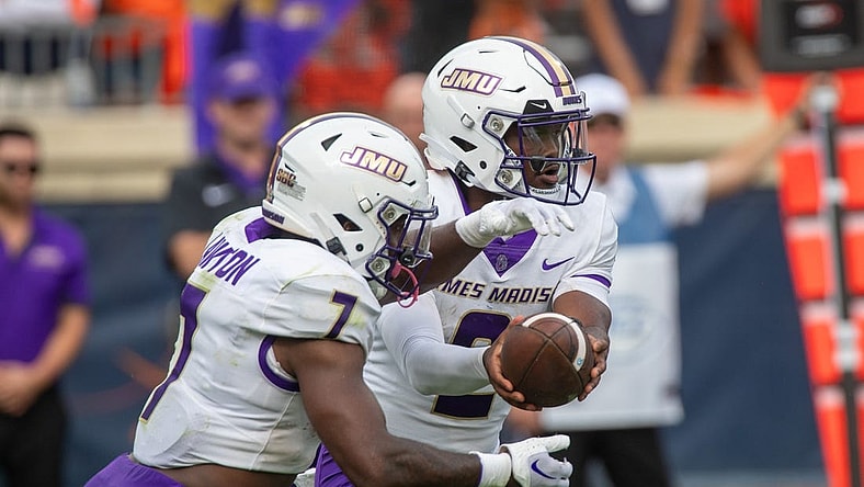 Sept 9, 2023; Charlottesville, Virginia, USA; James Madison Dukes quarterback Jordan McCloud (2) passes off the ball to James Madison Dukes running back Ty Son Lawton (7) to run a play during the second half at Scott Stadium. Mandatory Credit: Hannah Pajewski-USA TODAY Sports