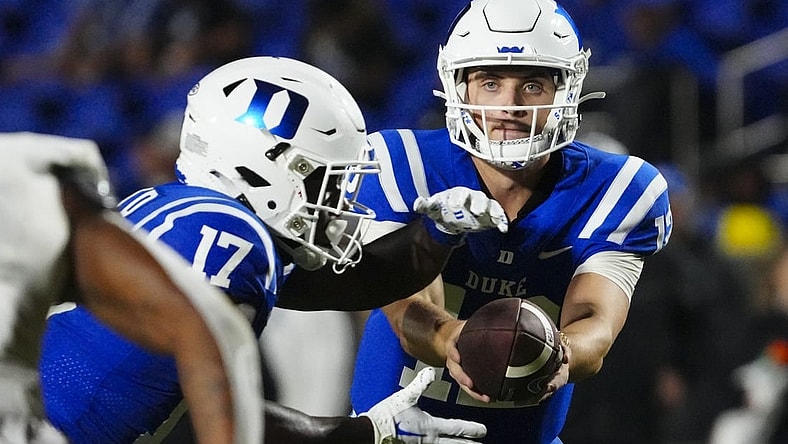 Sep 9, 2023; Durham, North Carolina, USA;  Duke Blue Devils quarterback Grayson Loftis (12) hands off the ball to  wide receiver Quran Boyd (17) against the Lafayette Leopards during the second half at Wallace Wade Stadium. Mandatory Credit: James Guillory-USA TODAY Sports