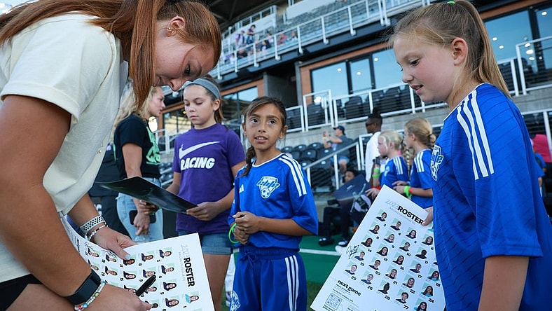 Sep 15, 2023; Louisville, Kentucky, USA; Racing Louisville FC goalkeeper Jordyn Bloomer (24) signs autographs before the match against the Houston Dash at Lynn Family Stadium. Mandatory Credit: EM Dash-USA TODAY Sports