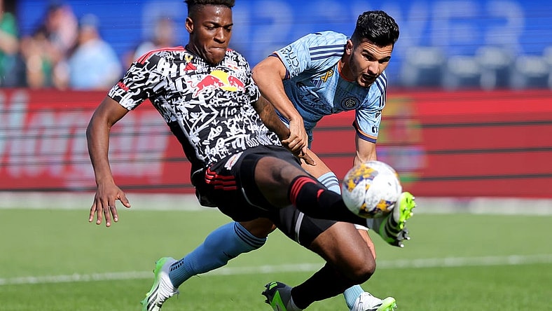 Sep 16, 2023; New York, New York, USA; New York Red Bulls defender Hassan Ndam (98) plays the ball against New York City FC forward Mounsef Bakrar (9) during the first half at Yankee Stadium. Mandatory Credit: Brad Penner-USA TODAY Sports