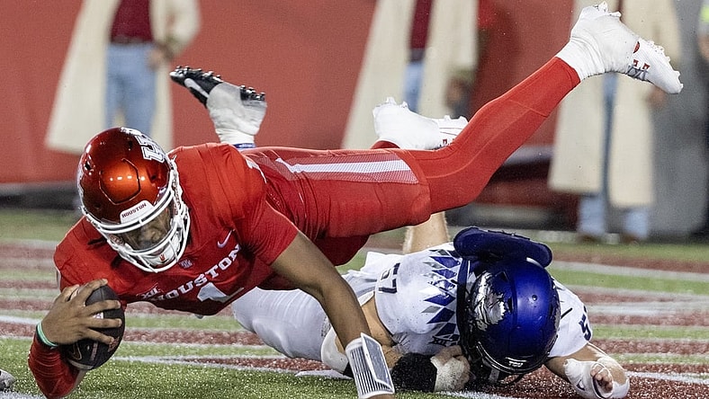Sep 16, 2023; Houston, Texas, USA; Houston Cougars wide receiver Samuel Brown (4) is tackled by TCU Horned Frogs linebacker Johnny Hodges (57) on the one yard line in the second half at TDECU Stadium. Mandatory Credit: Thomas Shea-USA TODAY Sports
