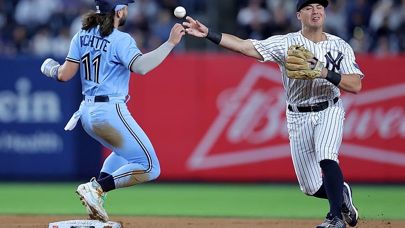 Sep 19, 2023; Bronx, New York, USA; New York Yankees shortstop Anthony Volpe (11) forces Toronto Blue Jays shortstop Bo Bichette (11) out at second and throws to first to complete a double play on a ball hit by designated hitter Vladimir Guerrero Jr. (not pictured) during the first inning at Yankee Stadium. Mandatory Credit: Brad Penner-USA TODAY Sports