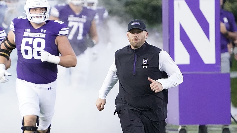 Sep 23, 2023; Evanston, Illinois, USA; Northwestern Wildcats head coach David Braun leads his team on the field before the game against the Minnesota Golden Gophers at Ryan Field. Mandatory Credit: David Banks-USA TODAY Sports